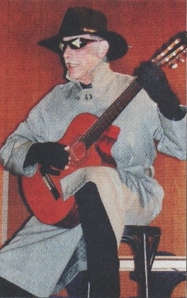 Liedermacher Hans-Peter Lendle sitzt als der "Gentechnik-Mann" mit Gitarre auf der Bühne